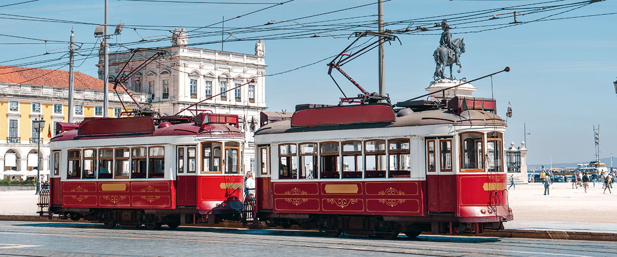 Vintage trams travelling down a street in Lisbon, Portugal